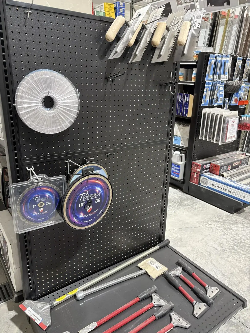 Blade and scraper wall at Sundry Pro Shop with diamond saw blades, floor scrapers and replacement blades
