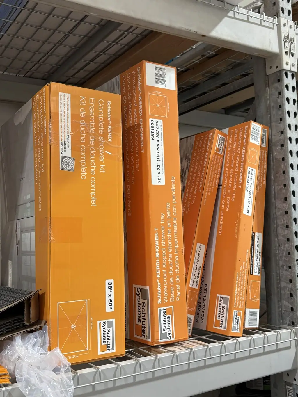 Schluter KERDI complete shower kits and KERDI-SHOWER-T sloped trays on shelving at Sundry Pro Shop