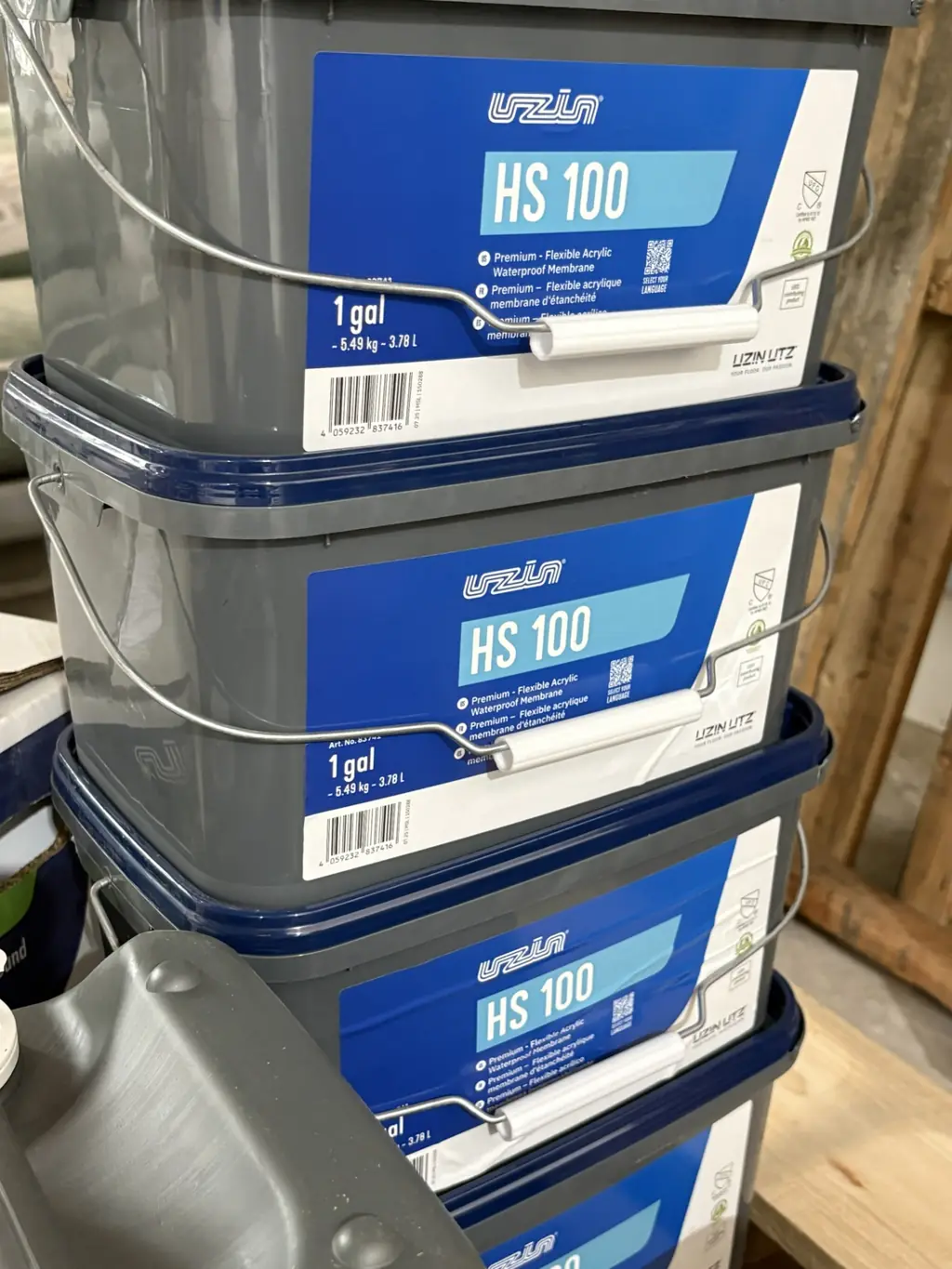 Stack of Uzin HS 100 flexible acrylic waterproof membrane 1 gallon pails at Sundry Pro Shop
