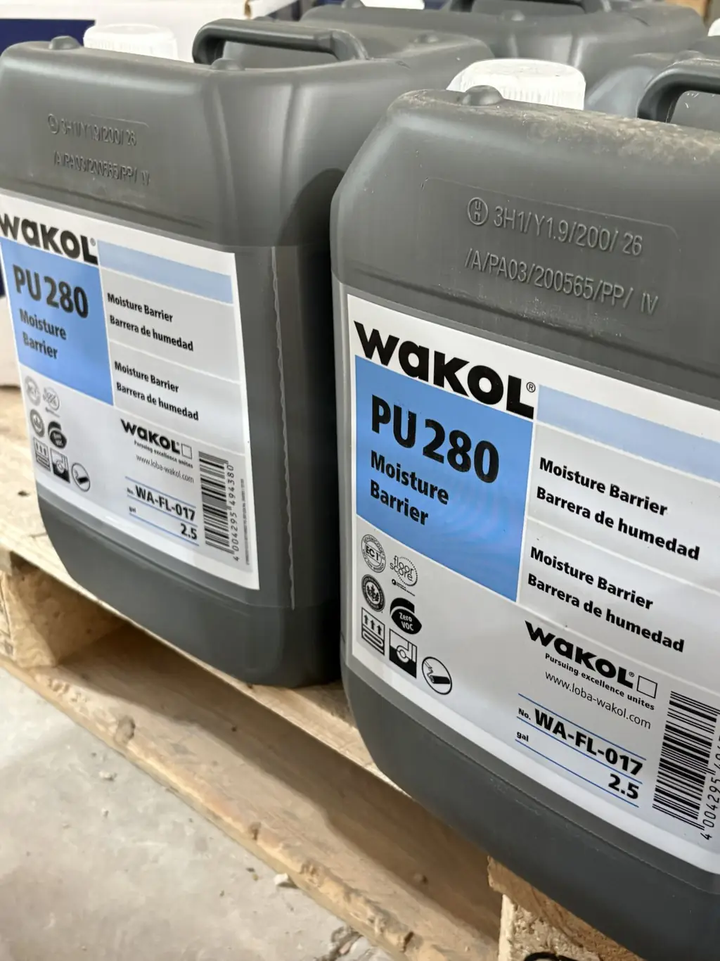 Wakol PU 280 moisture barrier 2.5 gallon jugs on a pallet at Sundry Pro Shop